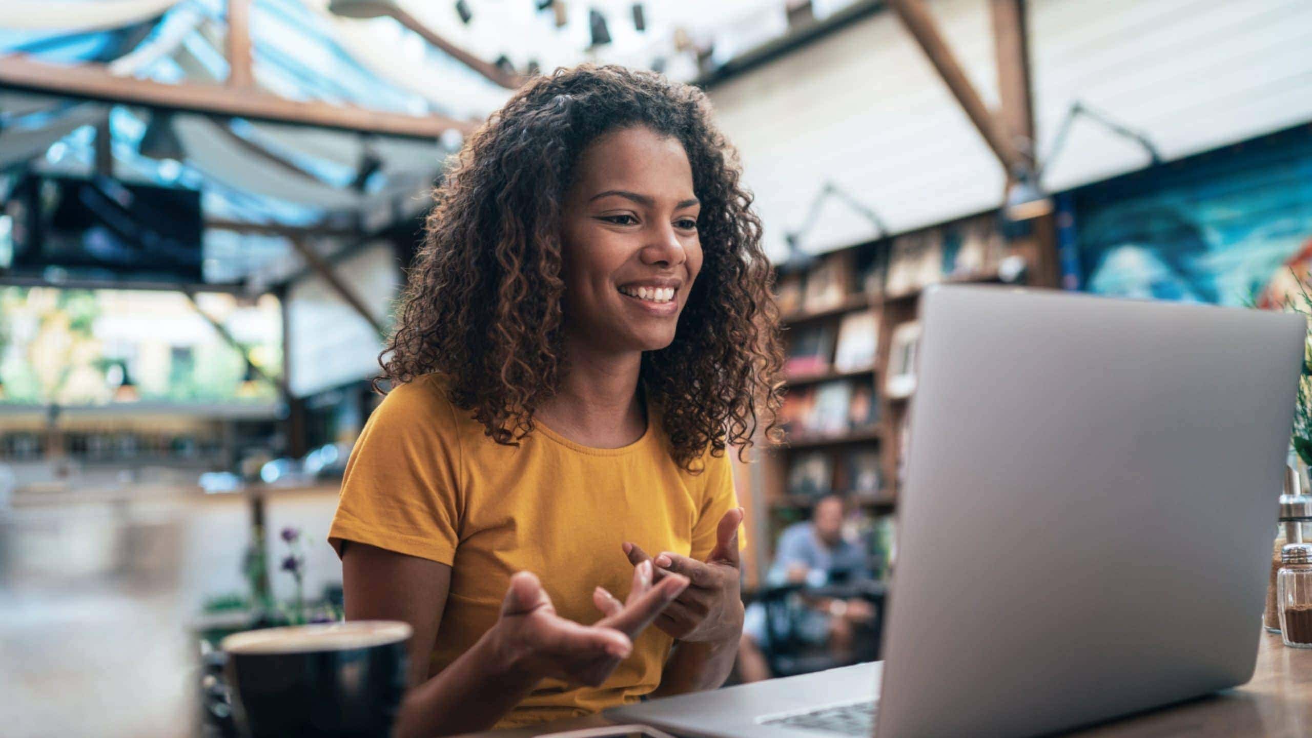 A Woman with Laptop - Talent Trust Compass Group video meeting