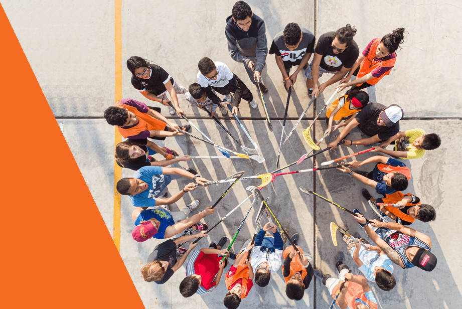 A group huddle of floorball players linked to our travel medical insurance's no claims bonus benefit