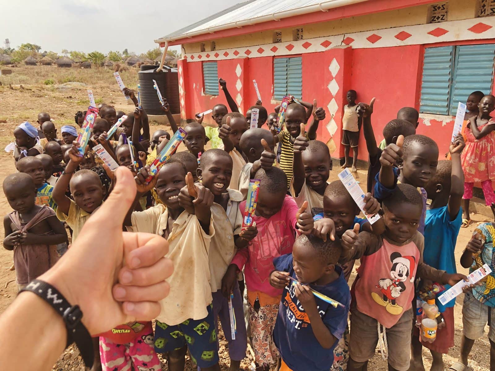 Local kids giving our missionary insurance member the thumbs up after some fun and games